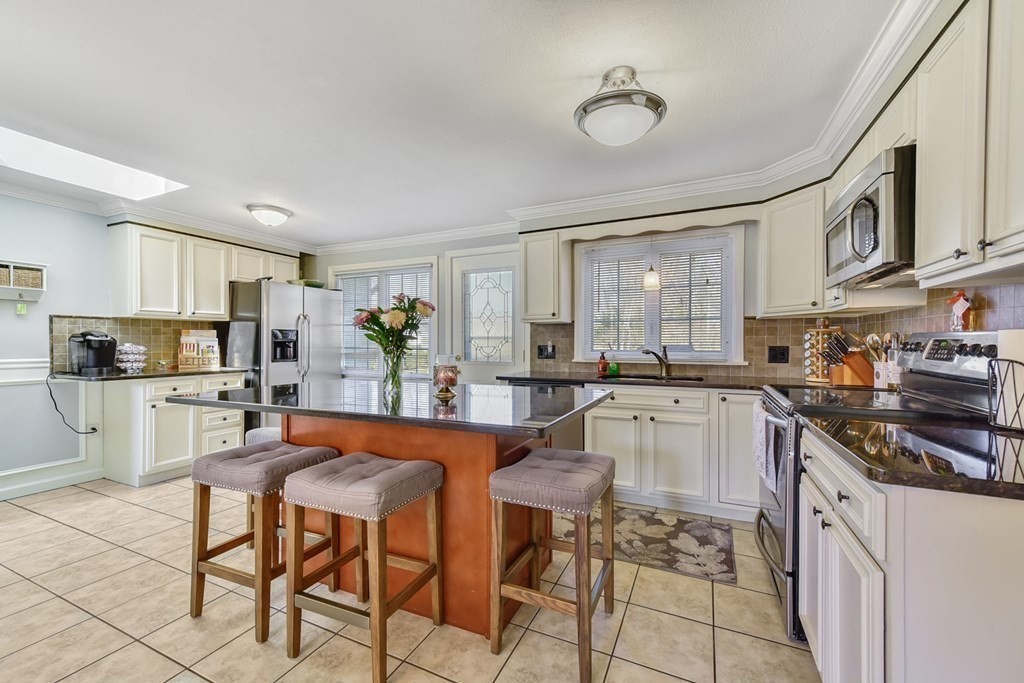 322 Wolf Swamp Road Longmeadow, MA 01106 - Photo 4 of 24 a kitchen with stainless steel appliances kitchen island granite countertop a sink and cabinets