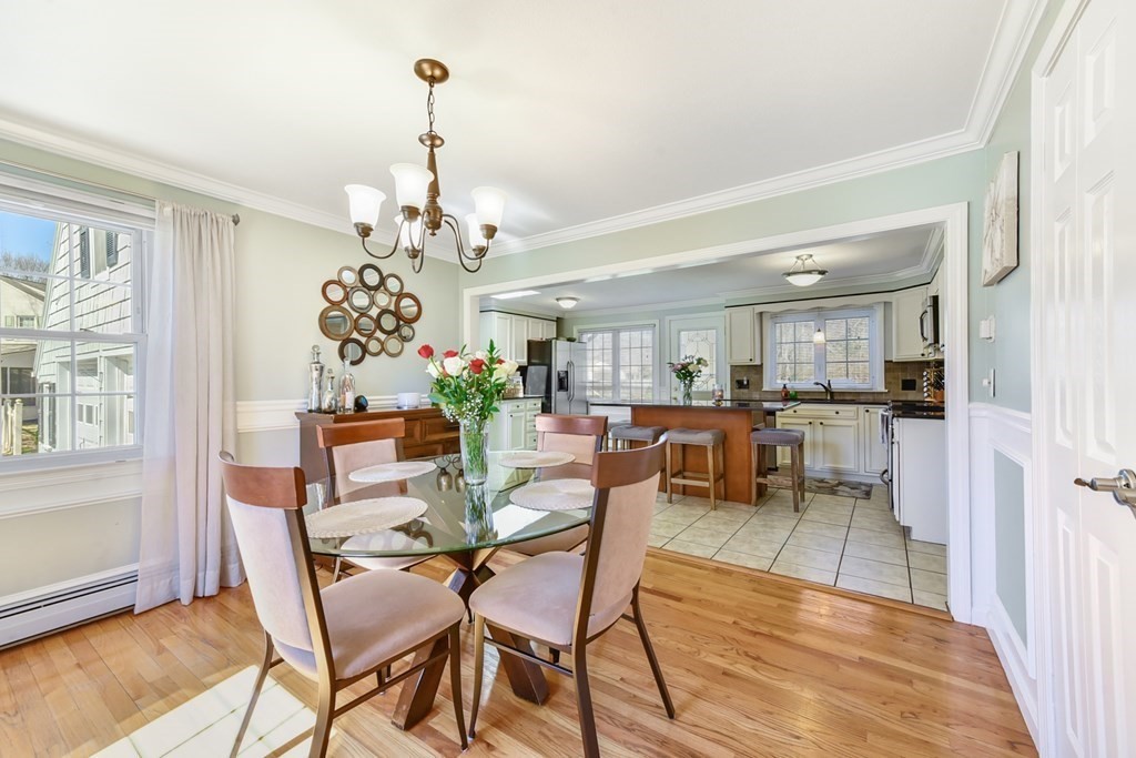 322 Wolf Swamp Road Longmeadow, MA 01106 - Photo 9 of 24 a dining room with furniture a chandelier and wooden floor