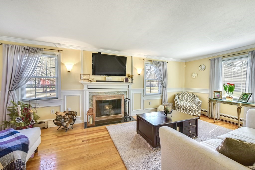 322 Wolf Swamp Road Longmeadow, MA 01106 - Photo 10 of 24 a living room with furniture a fireplace and a flat screen tv