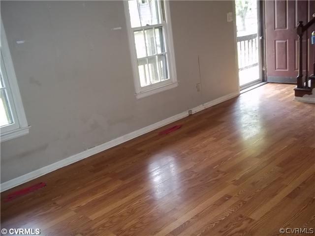 13917 Hackberry Road Chester, VA 23836 - Photo 2 of 10 an empty room with wooden floor and windows
