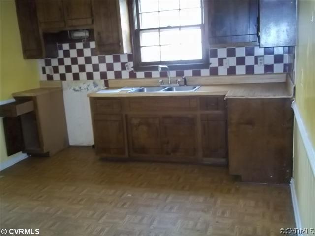 13917 Hackberry Road Chester, VA 23836 - Photo 4 of 10 a kitchen with a sink and cabinets