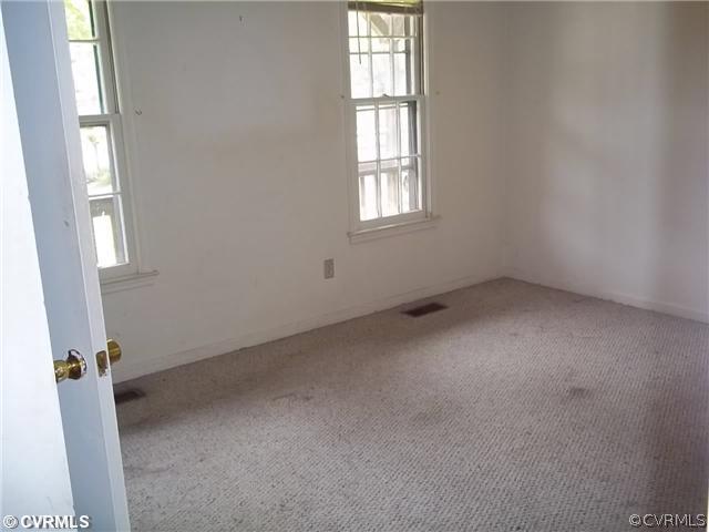 13917 Hackberry Road Chester, VA 23836 - Photo 5 of 10 an empty room with windows