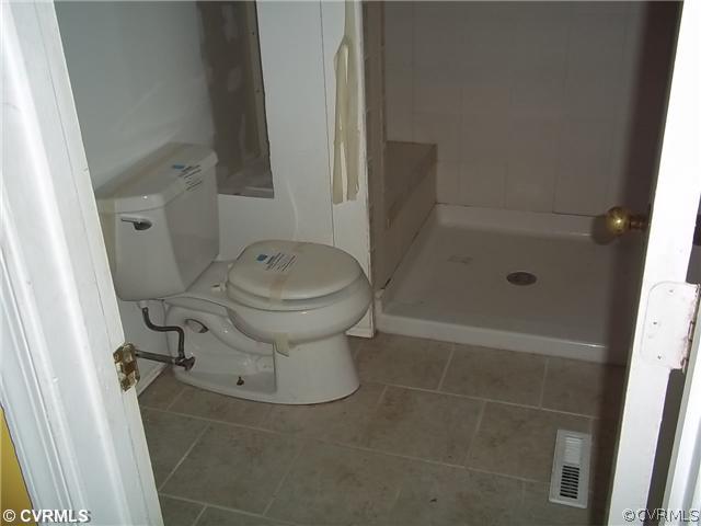 13917 Hackberry Road Chester, VA 23836 - Photo 7 of 10 a bathroom with a sink toilet and shower