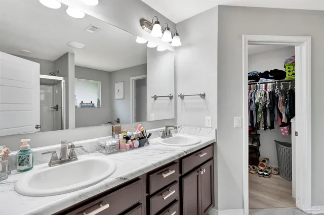 a bathroom with a sink double vanity and a mirror