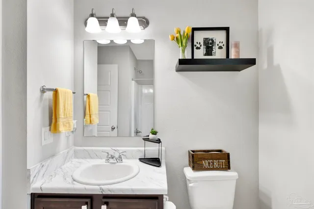 a bathroom with a sink and a mirror with toilet