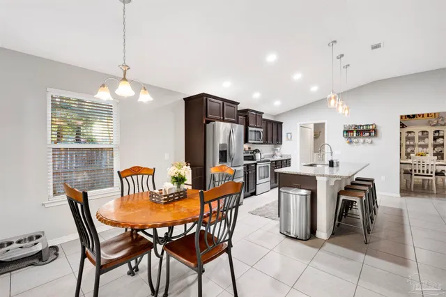 a view of a dining room with furniture and a chandelier