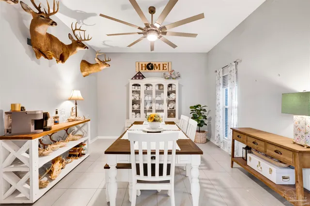 a living room with furniture a chandelier and a dining table