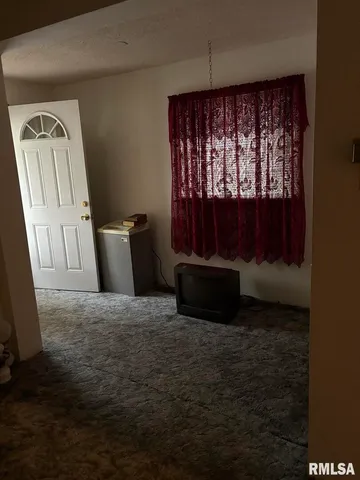 a view of an empty room with a fireplace