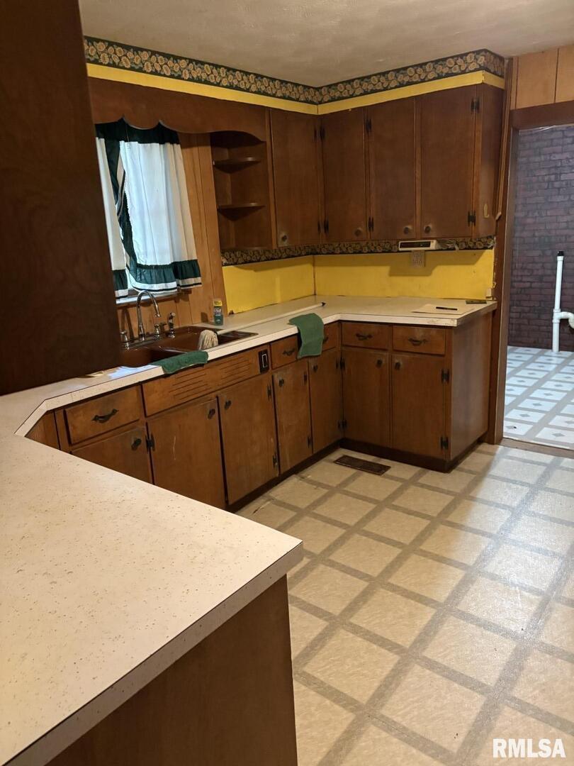1606 West Faust Street Marion, IL 62959 - Photo 15 of 29 a kitchen with a sink a stove top oven and a refrigerator