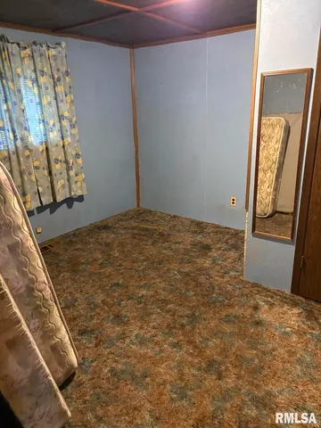 a view of a room with a chandelier fan and window