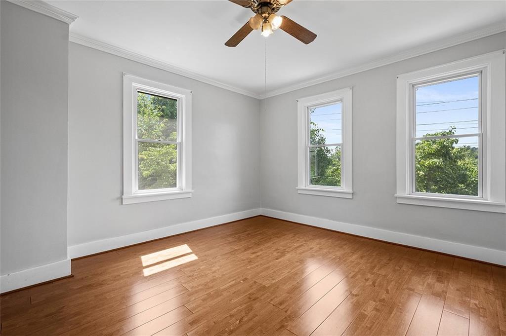 1815 Main Street Bridgeville, PA 15017 - Photo 13 of 32 a view of an empty room with wooden floor and a window