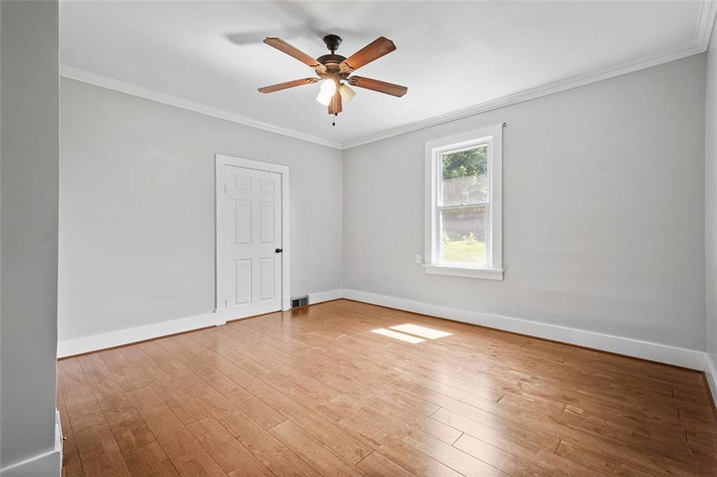 1815 Main Street Bridgeville, PA 15017 - Photo 15 of 32 an empty room with wooden floor and windows