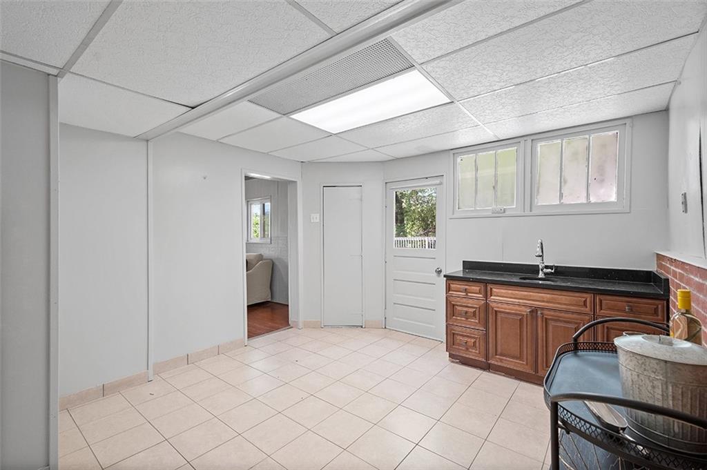 1815 Main Street Bridgeville, PA 15017 - Photo 23 of 32 a kitchen with granite countertop a sink stove and cabinets