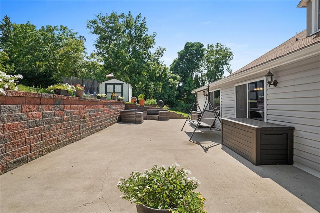 1815 Main Street Bridgeville, PA 15017 - Photo 29 of 32 a view of a patio with table and chairs with wooden fence and plants
