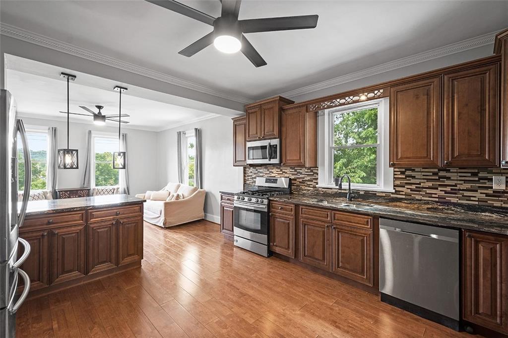1815 Main Street Bridgeville, PA 15017 - Photo 6 of 32 a large kitchen with stainless steel appliances granite countertop a stove and a sink