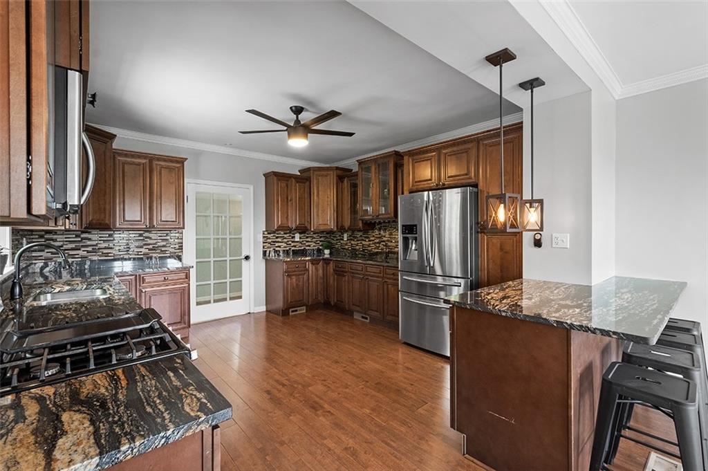 1815 Main Street Bridgeville, PA 15017 - Photo 7 of 32 a kitchen with stainless steel appliances granite countertop a stove refrigerator sink and dishwasher