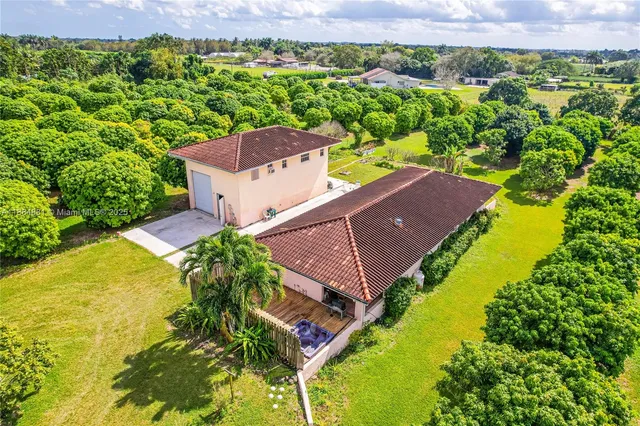 an aerial view of a house with a garden and swimming pool