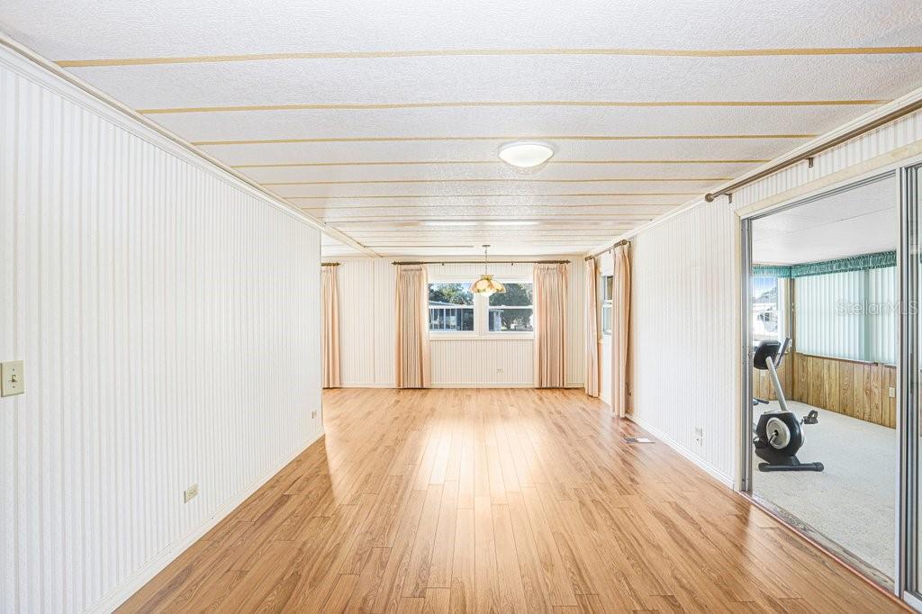 14299 Nectarine Street Brooksville, FL 34613 - Photo 12 of 41 a view of an empty room with wooden floor and a window