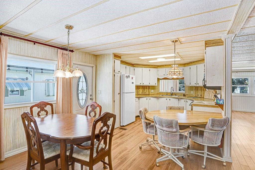 14299 Nectarine Street Brooksville, FL 34613 - Photo 16 of 41 a dining room with stainless steel appliances furniture a chandelier and kitchen view