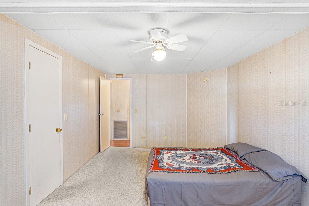 14299 Nectarine Street Brooksville, FL 34613 - Photo 20 of 41 a bedroom with a bed and a chandelier