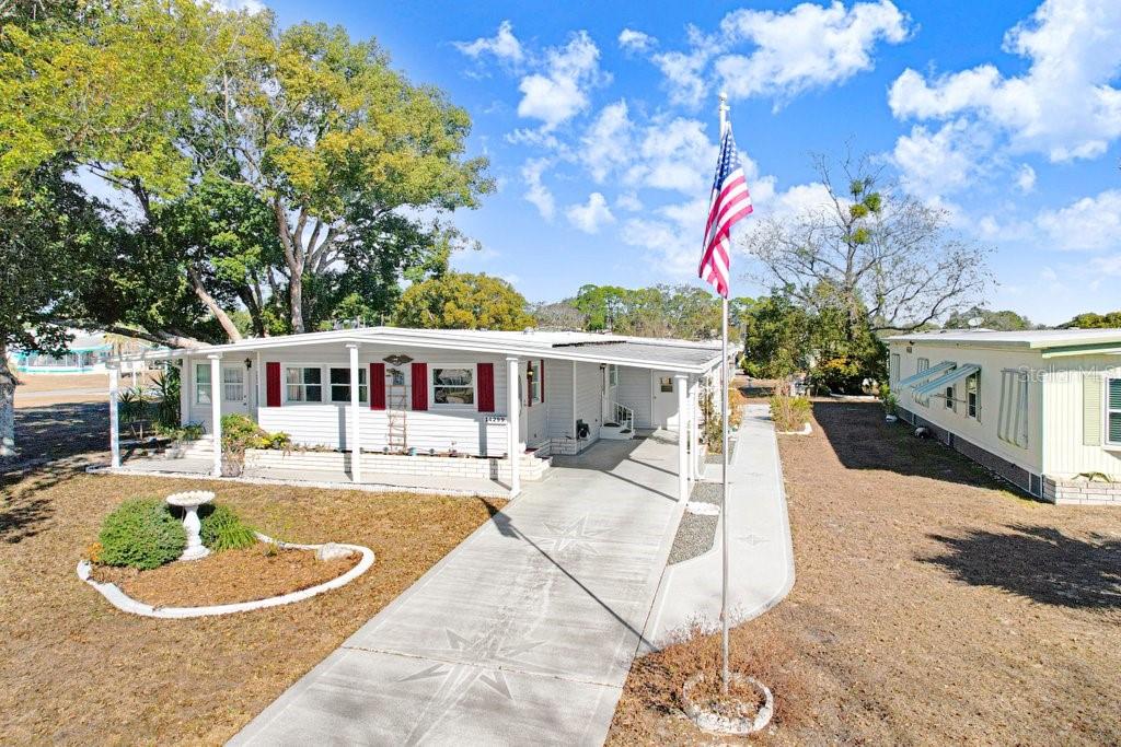 14299 Nectarine Street Brooksville, FL 34613 - Photo 2 of 41 a front view of a house with a yard patio and fire pit