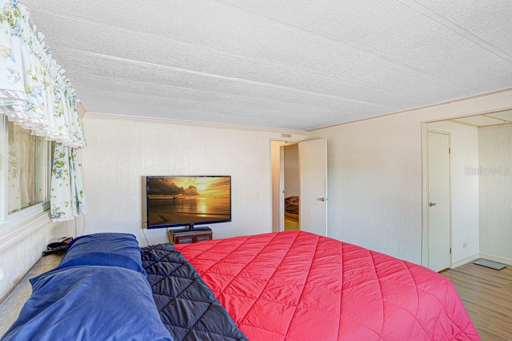 14299 Nectarine Street Brooksville, FL 34613 - Photo 22 of 41 a bedroom with a bed and a flat screen tv