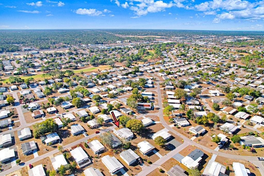 14299 Nectarine Street Brooksville, FL 34613 - Photo 32 of 41 an aerial view of a city with lots of residential buildings and ocean view in back