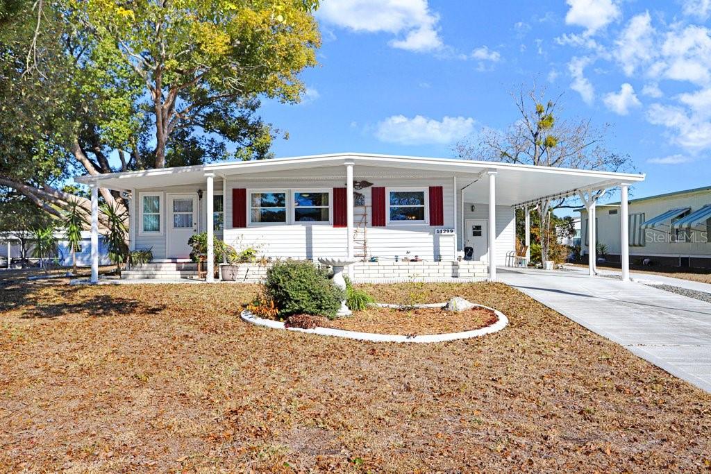 14299 Nectarine Street Brooksville, FL 34613 - Photo 4 of 41 a front view of a house with a yard and potted plants