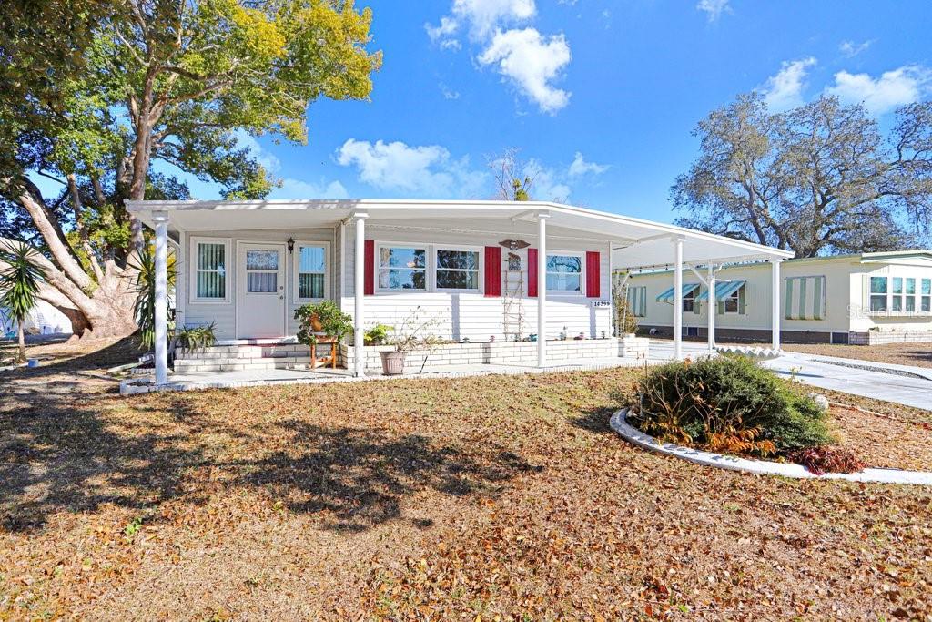 14299 Nectarine Street Brooksville, FL 34613 - Photo 5 of 41 a front view of a house with garden