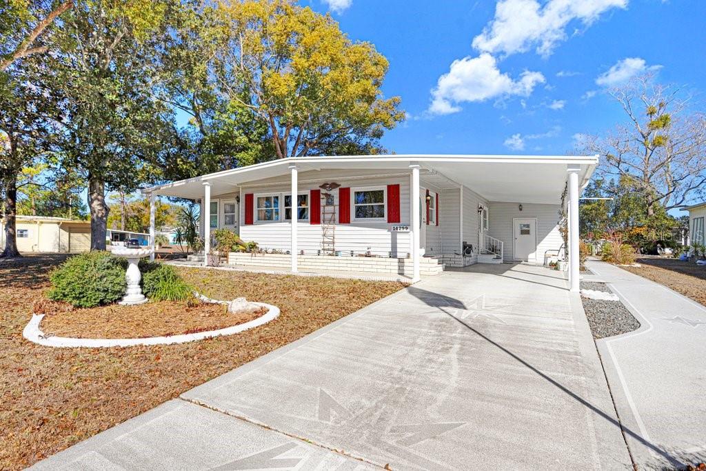 14299 Nectarine Street Brooksville, FL 34613 - Photo 6 of 41 a front view of a house with a yard and potted plants