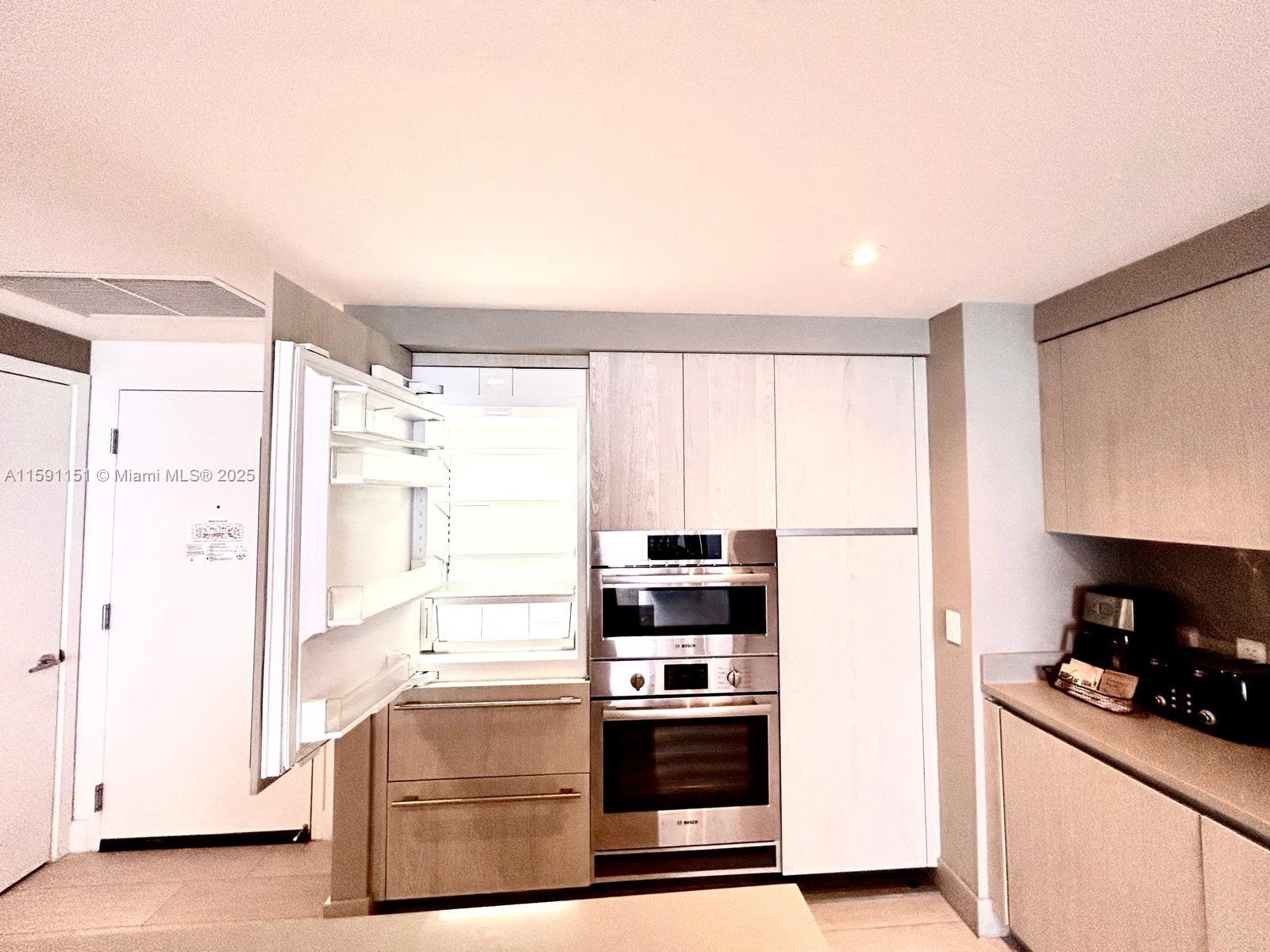 4010 South Ocean Drive, Unit R2407 Hollywood, FL 33019 - Photo 21 of 33 a kitchen with stainless steel appliances a stove and a refrigerator