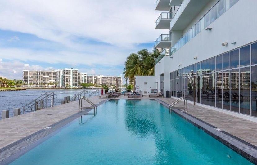 4010 South Ocean Drive, Unit R2407 Hollywood, FL 33019 - Photo 5 of 33 a view of a swimming pool with a patio