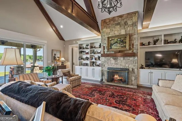a living room with furniture a fireplace and wooden floor