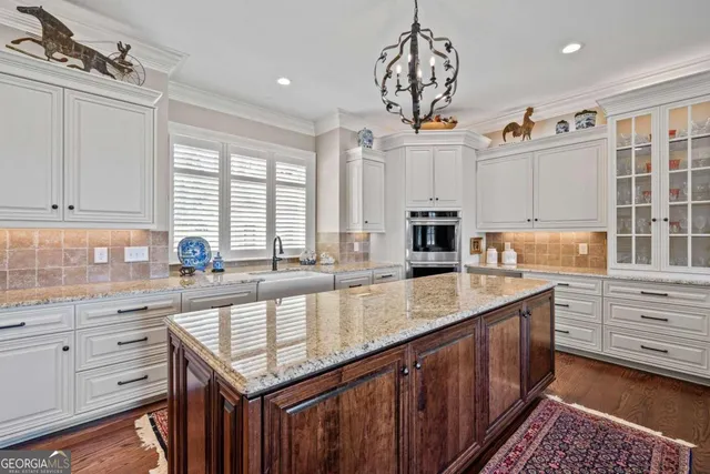 a small pool with lawn chairs under an umbrella