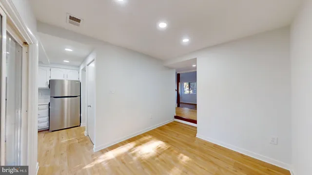 a view of a kitchen with a sink and a refrigerator