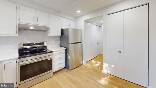 a kitchen with a stove and a refrigerator