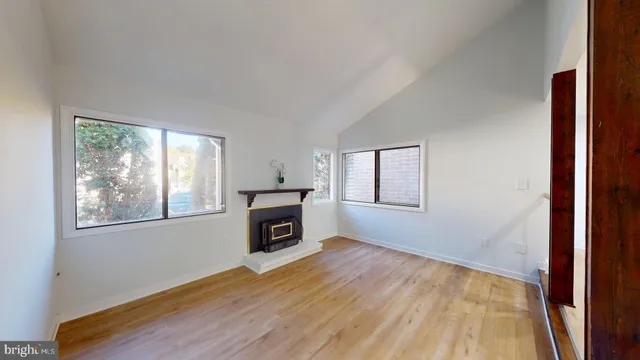 a view of main area fire place window and wooden floor