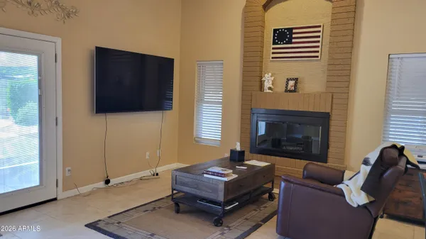 a view of a hallway with wooden floor and windows