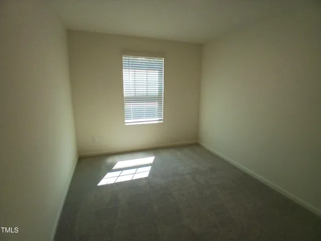 an empty room with closet area