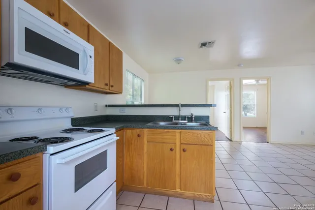 a kitchen with stainless steel appliances granite countertop a stove and a microwave