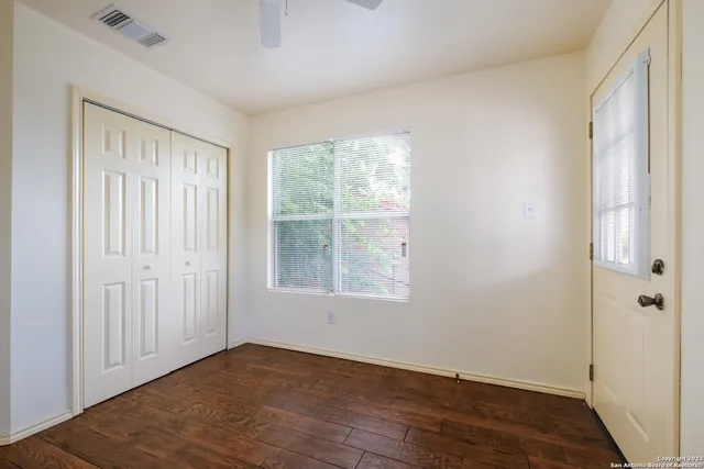 wooden floor in an empty room with a window