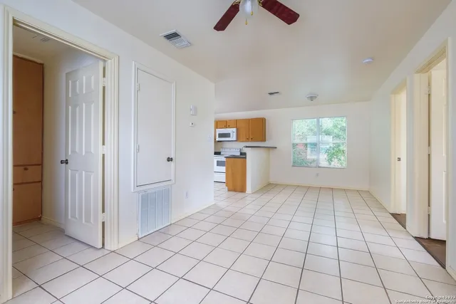 an empty room with windows and closet