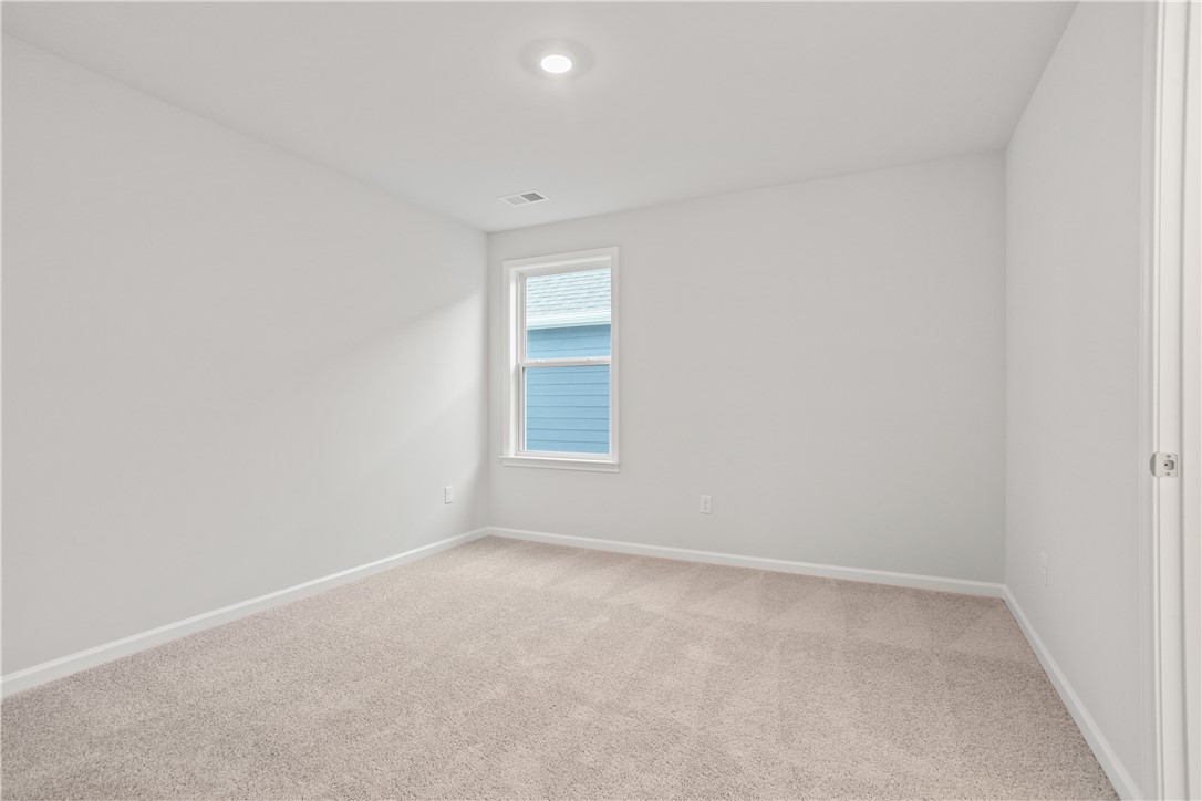 629 Sweetspire Trail, Unit 149 Seneca, SC 29678 - Photo 19 of 30 A well-lit bedroom features plush carpeting and a bright window overlooking the neighborhood.