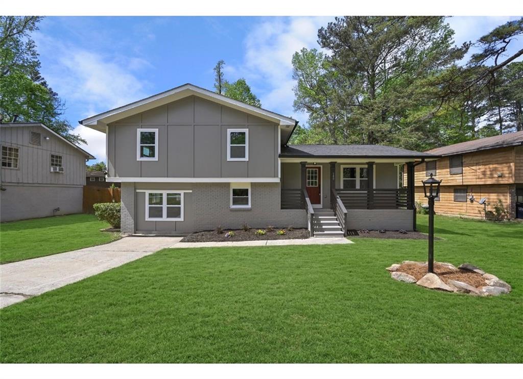 a front view of a house with a yard and porch