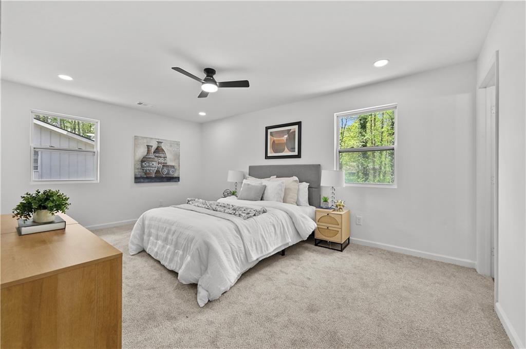 140 Buckhurst Way South Fulton, GA 30349 - Photo 17 of 45 a spacious bedroom with a bed and a chandelier