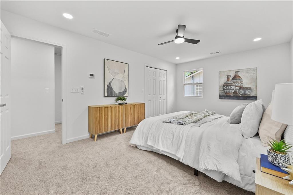 140 Buckhurst Way South Fulton, GA 30349 - Photo 18 of 45 a bedroom with a bed and a chandelier