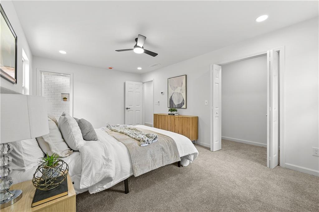 140 Buckhurst Way South Fulton, GA 30349 - Photo 19 of 45 a spacious bedroom with a bed and a chandelier