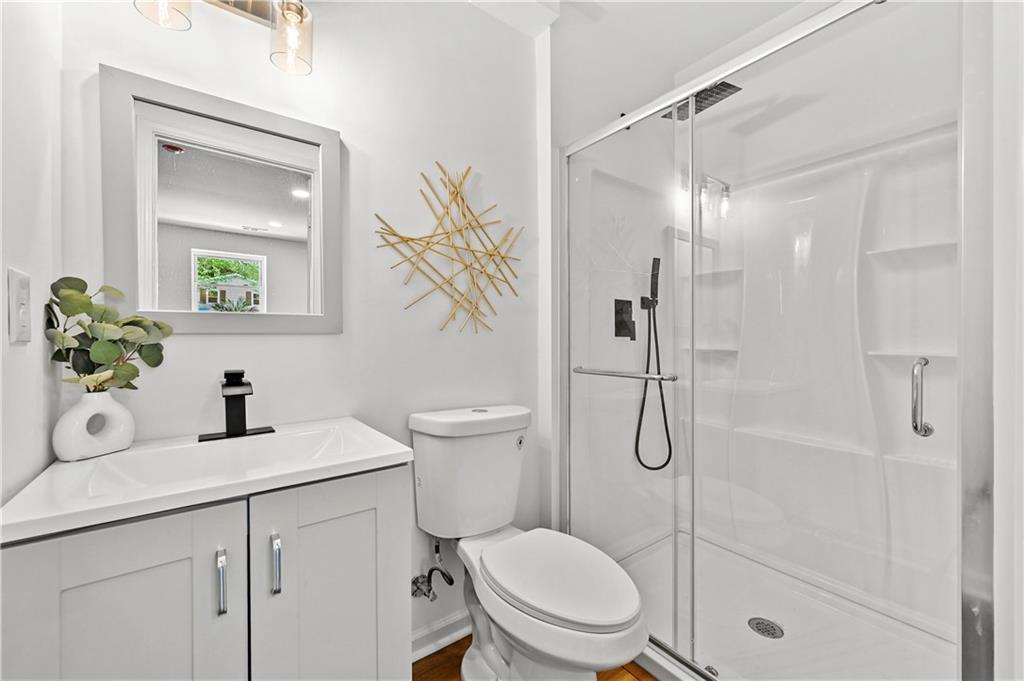 140 Buckhurst Way South Fulton, GA 30349 - Photo 29 of 45 a bathroom with a shower sink vanity mirror and toilet