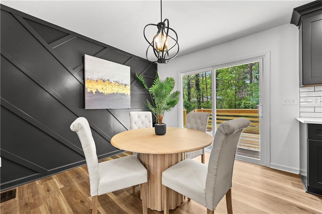 140 Buckhurst Way South Fulton, GA 30349 - Photo 6 of 45 a dining room with furniture potted plants and wooden floor