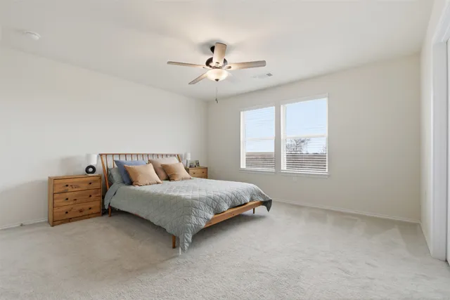 a bedroom with bed and window